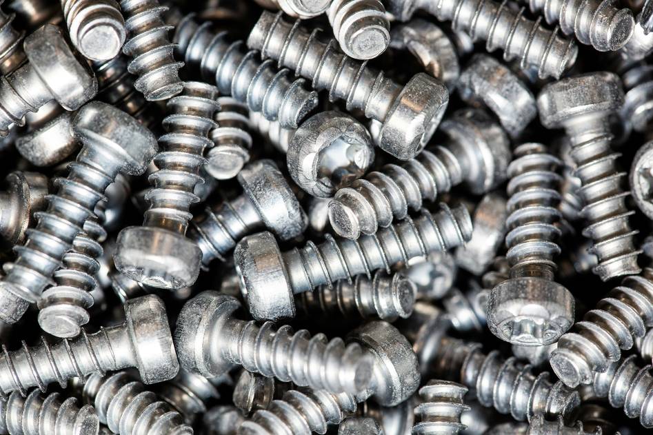 Close-up of precision screw threads on metal surface