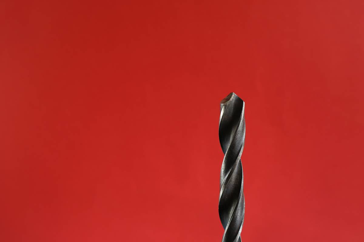 Close-up of drilling pilot hole for easy out for small screws
